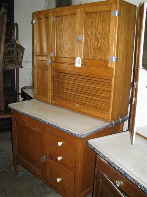 A few examples of appraisal values forHOOSIER CABINET. Search our price guide for your own treasures. Oak 2-pc Hoosier cabinet, top with 4. Oak 2-pc Hoosier cabinet, top with 4 doors with stained glass inserts at top, tambour door, base with enamel top over three drawers over single door, 69"h x 39"w x 12"d. 